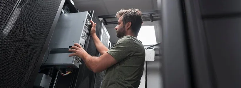 IT engineer working on availability uptime and downtime in server room